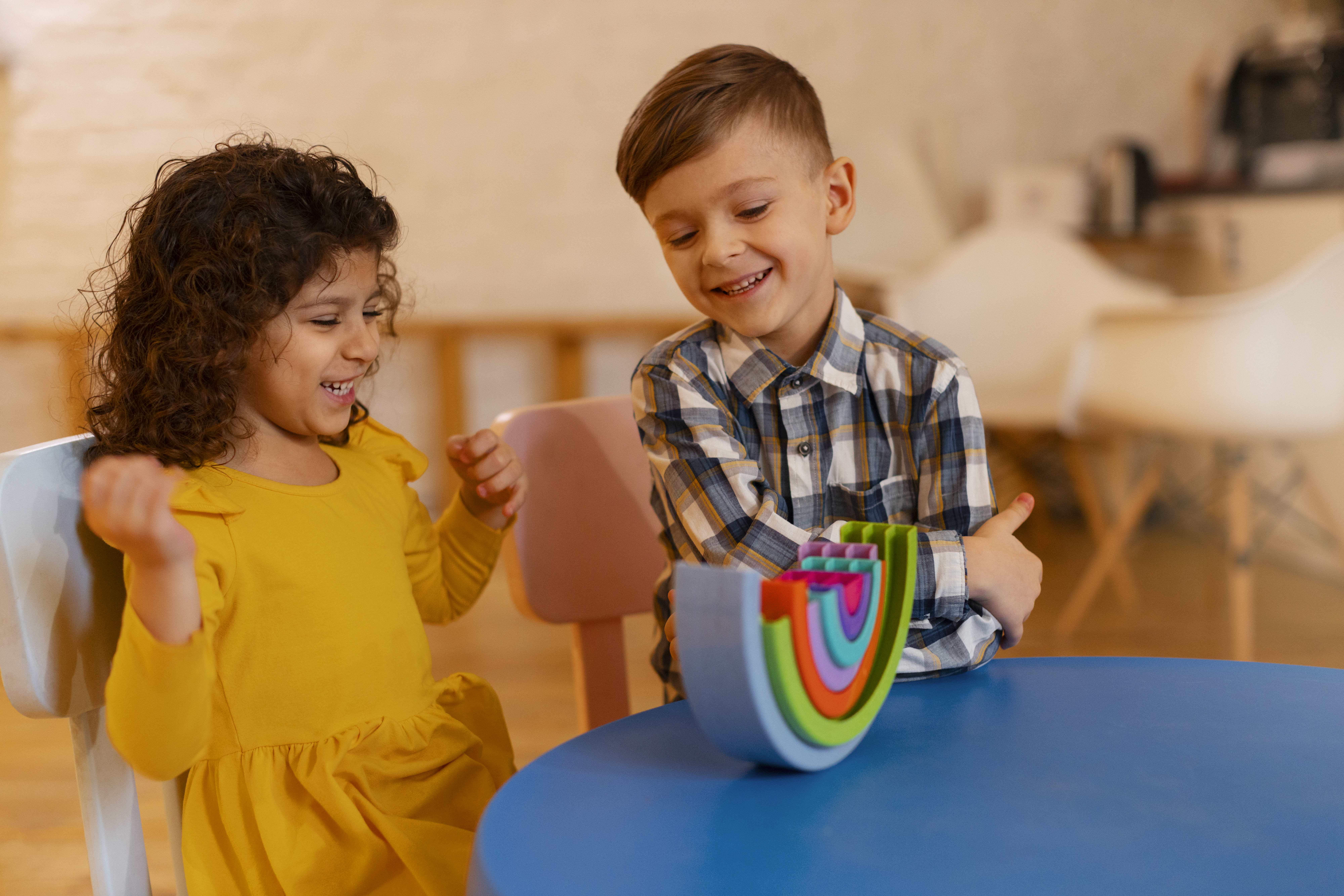 young boy girl playing indoors with eco toys